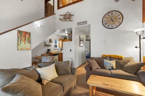 a living room with a couch and a clock on the wall at Valley View - Carson Valley Views in Stateline