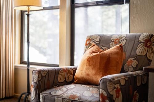 a couch with a pillow in front of a window at Lakeland Sandy Beach Retreat - Private Escape in South Lake Tahoe