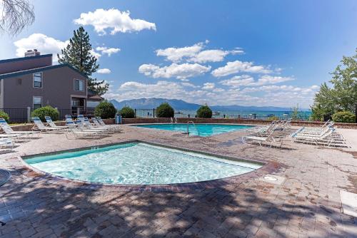 a swimming pool with lounge chairs and a house at Lakeland Sandy Beach Retreat - Private Escape in South Lake Tahoe