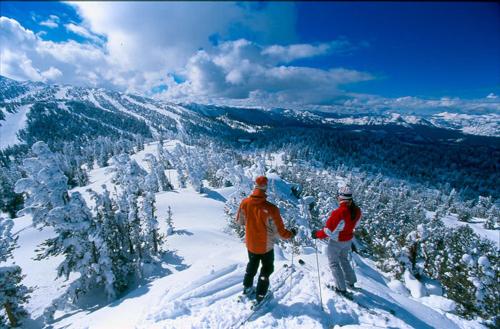 two people standing on top of a snow covered mountain at Lakeland Sandy Beach Retreat - Private Escape in South Lake Tahoe