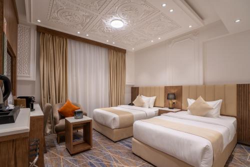 Postel nebo postele na pokoji v ubytování Nars Plus Al Naeem Hotel