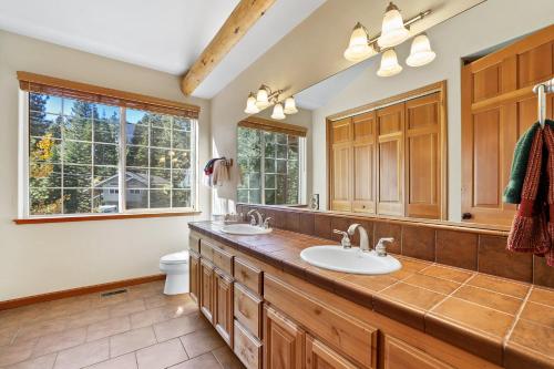 a bathroom with two sinks and a toilet at The Lodge on Oaxaco - Epic Man Cave with Billiard Room in South Lake Tahoe