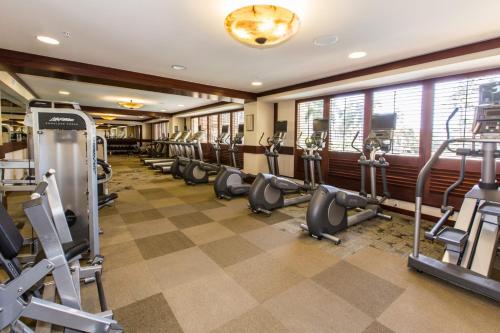 a gym with a row of treadms and cardio machines at Beachfront Condo in Ko Olina Paradise in Kapolei