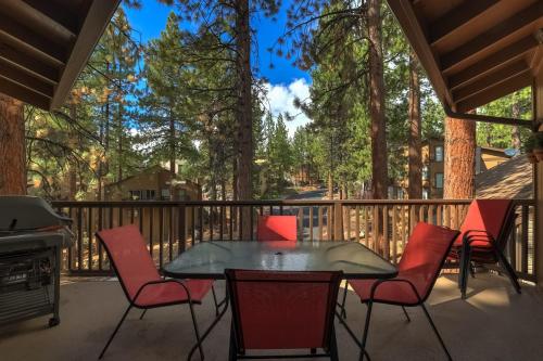 a patio with a table and chairs and a grill at Family Fun Getaway - 3 Story Condo in Zephyr Cove