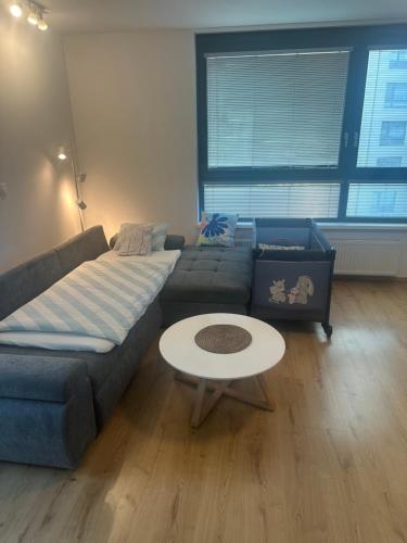 a living room with a couch and a table at CityPark Apartment, free parking & AC in Bratislava