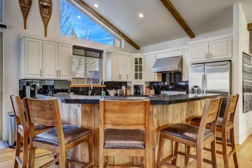 a kitchen with a large island with four chairs at Luxe Mountain Chalet - Hot tub Man Cave Foosball Peloton in South Lake Tahoe
