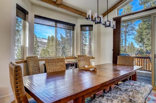 a dining room with a wooden table and chairs at Luxe Mountain Chalet - Hot tub Man Cave Foosball Peloton in South Lake Tahoe