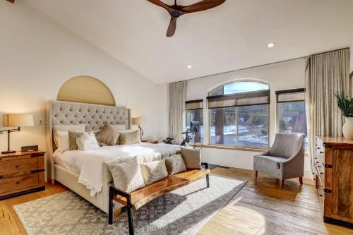 a bedroom with a large bed and a chair at Luxe Mountain Chalet - Hot tub Man Cave Foosball Peloton in South Lake Tahoe
