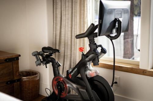 an exercise bike in a room next to a window at Luxe Mountain Chalet - Hot tub Man Cave Foosball Peloton in South Lake Tahoe