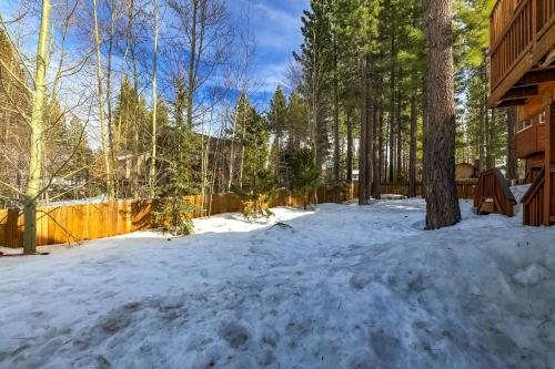 a yard covered in snow next to a fence at Luxe Mountain Chalet - Hot tub Man Cave Foosball Peloton in South Lake Tahoe