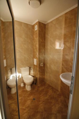 a bathroom with a toilet and a sink at Hotel Marant in Sozopol