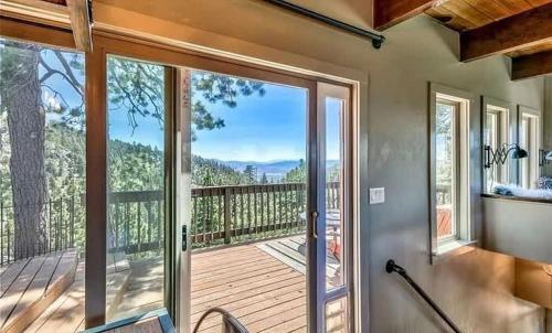a sliding glass door to a deck with a view at Heaven's Nest - the BEST views of Lake Tahoe in Stateline