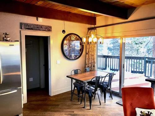 a dining room with a table and chairs on a balcony at Heaven's Nest - the BEST views of Lake Tahoe in Stateline