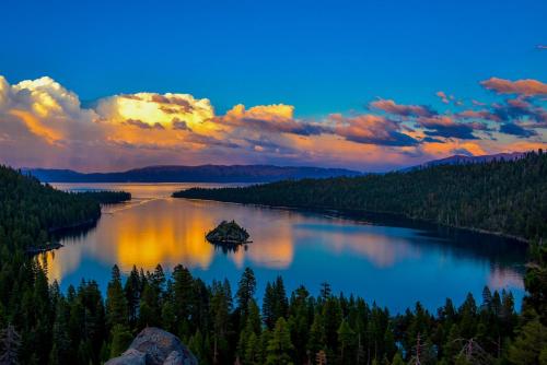 a view of a lake at sunset with trees at Heaven's Nest - the BEST views of Lake Tahoe in Stateline