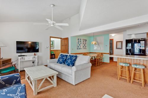 a living room with a couch and a kitchen at PS-I -Swan Sea in Duck