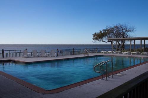 a large swimming pool next to the ocean at PS-I -Swan Sea in Duck