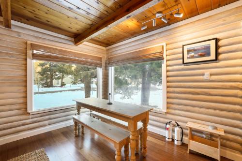 a wooden room with a table and a window at Augies Authentic Log Cabin Pets Welcome in South Lake Tahoe