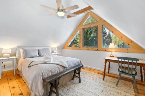 a bedroom with a bed and a desk and a window at Augies Authentic Log Cabin Pets Welcome in South Lake Tahoe