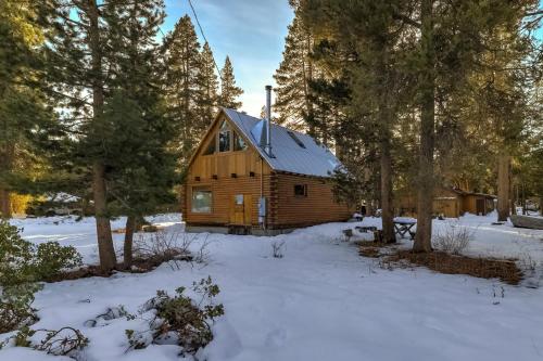 a log cabin in the woods in the snow at Augies Authentic Log Cabin Pets Welcome in South Lake Tahoe