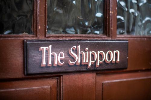 a wooden door with a sign that says the shipper at Nant Ucha Farm in Acrefair