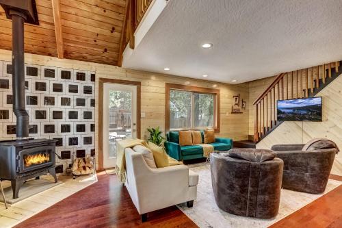 a living room with a fireplace and a stove at Rustic Haven - Hot tub & Pet friendly in South Lake Tahoe
