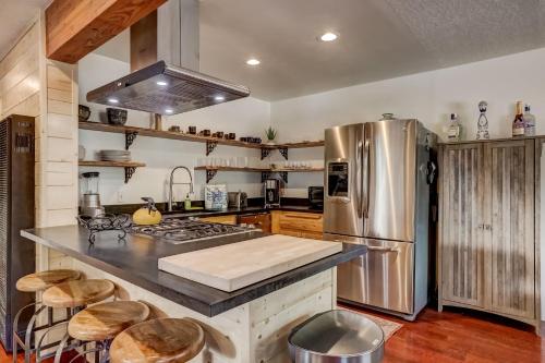 a kitchen with a stainless steel refrigerator and wooden cabinets at Rustic Haven - Hot tub & Pet friendly in South Lake Tahoe