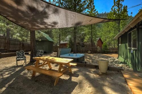 a patio with a picnic table and a tent at Rustic Haven - Hot tub & Pet friendly in South Lake Tahoe