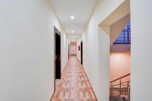 a corridor of a building with white walls and floors at Collection O Upper Bazar in Rānchī
