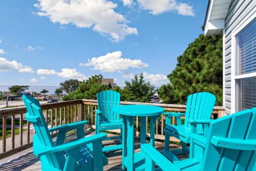 a patio with blue chairs and a table on a deck at 2000 - Pipers Paradise in Duck