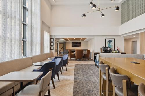 a waiting room at a hospital with tables and chairs at Staybridge Suites Sacramento Woodland by IHG in Woodland