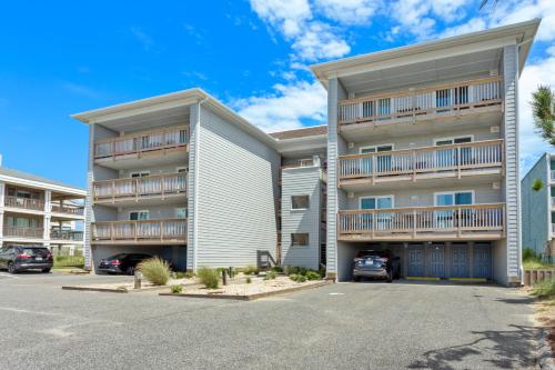 a large apartment building with a parking lot at YC301 - Life's Porpoise in Whalebone