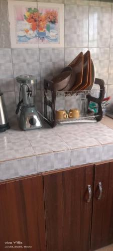 a kitchen counter with a mixer on top of it at Service apartment in Ibadan