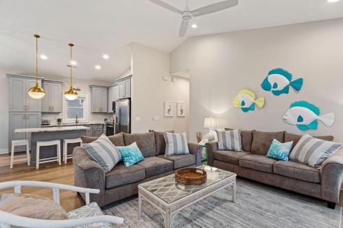 a living room with a couch and a table at 5046 - Pelican Palm in Kill Devil Hills