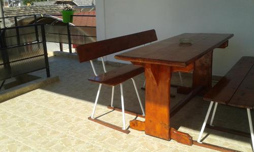 a wooden table and a chair in a room at Vila Lucky in Costinesti