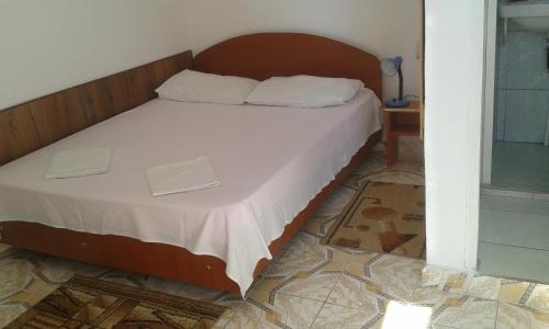 a bed with two boxes on it in a room at Vila Lucky in Costinesti