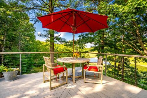 a table with two chairs and a red umbrella on a deck at Kayaks & Sup's - Private Dock - Grand Piano in Kittery