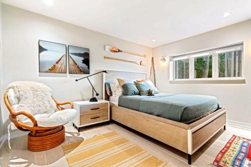 a bedroom with a bed and a chair at Kayaks & Sup's - Private Dock - Grand Piano in Kittery