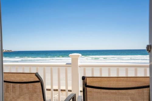 two chairs on a balcony looking at the beach at Beachfront Pet Friendly Sleeps 15 and BBQ in York