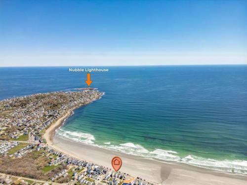 an aerial view of a beach with a yellow island in the water at Beachfront Pet Friendly Sleeps 15 and BBQ in York