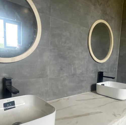 a bathroom with a white sink and a mirror at HS Villas in Zanzibar City