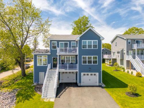 a large blue house with a driveway at Large Family Retreat Near Beach Private Decks in Wells