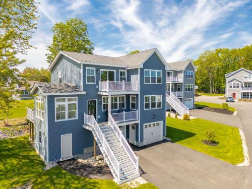 a large blue house with a yard at Large Family Retreat Near Beach Private Decks in Wells