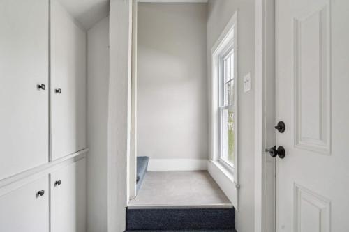 a hallway with a mirror next to a door at The Coastal Nest - Stay for 5 in Scarborough
