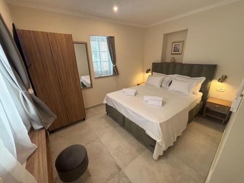 a bedroom with a large bed in a room at Heritage Villa Francheza-Elegant Stone villa near the Beach, Pašman Island , Ugrinić in Ugrinići