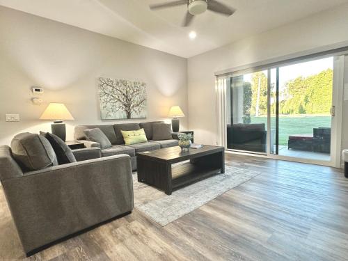 a living room with a couch and a table at Desert Princess Serenity Suite in Cathedral City