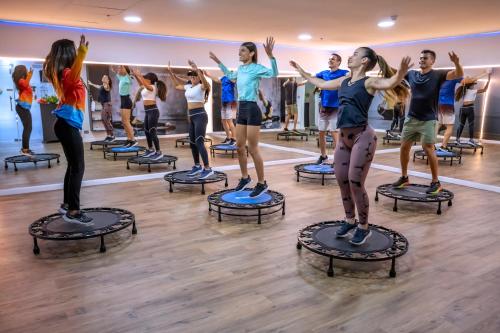 a group of people in a pilates class in a gym at Serhs Natal Grand Hotel & Resort in Natal