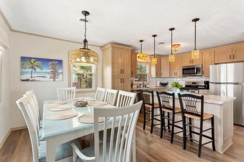 a kitchen and dining room with a table and chairs at 5206 - Hogg Heaven in Croatan Shores
