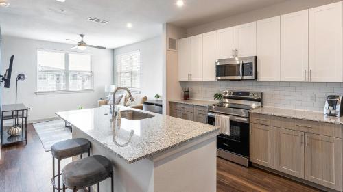 a kitchen with a sink and a counter top at Landing at Jameson - Rockwall in Rockwall