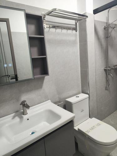 a bathroom with a sink and a toilet and a mirror at Spacious 1Br in Westlands in Nairobi