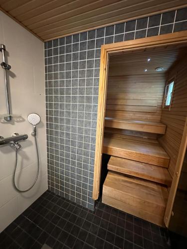 a bathroom with a shower and a staircase in a room at Virpiniemen Maston Villa, Oulu in Oulu
